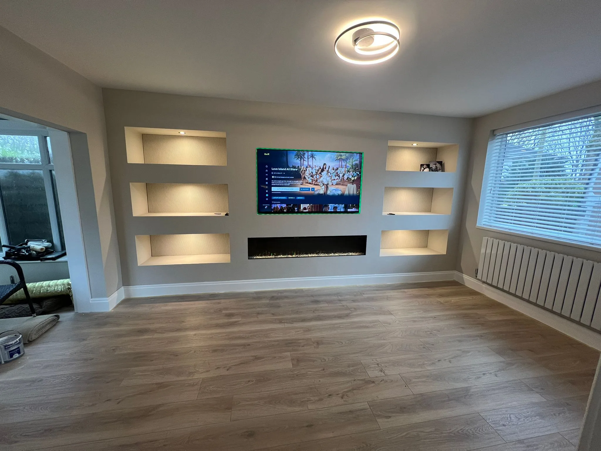 Bespoke media wall with feature shelving and fireplace by LDG Joinery LTD